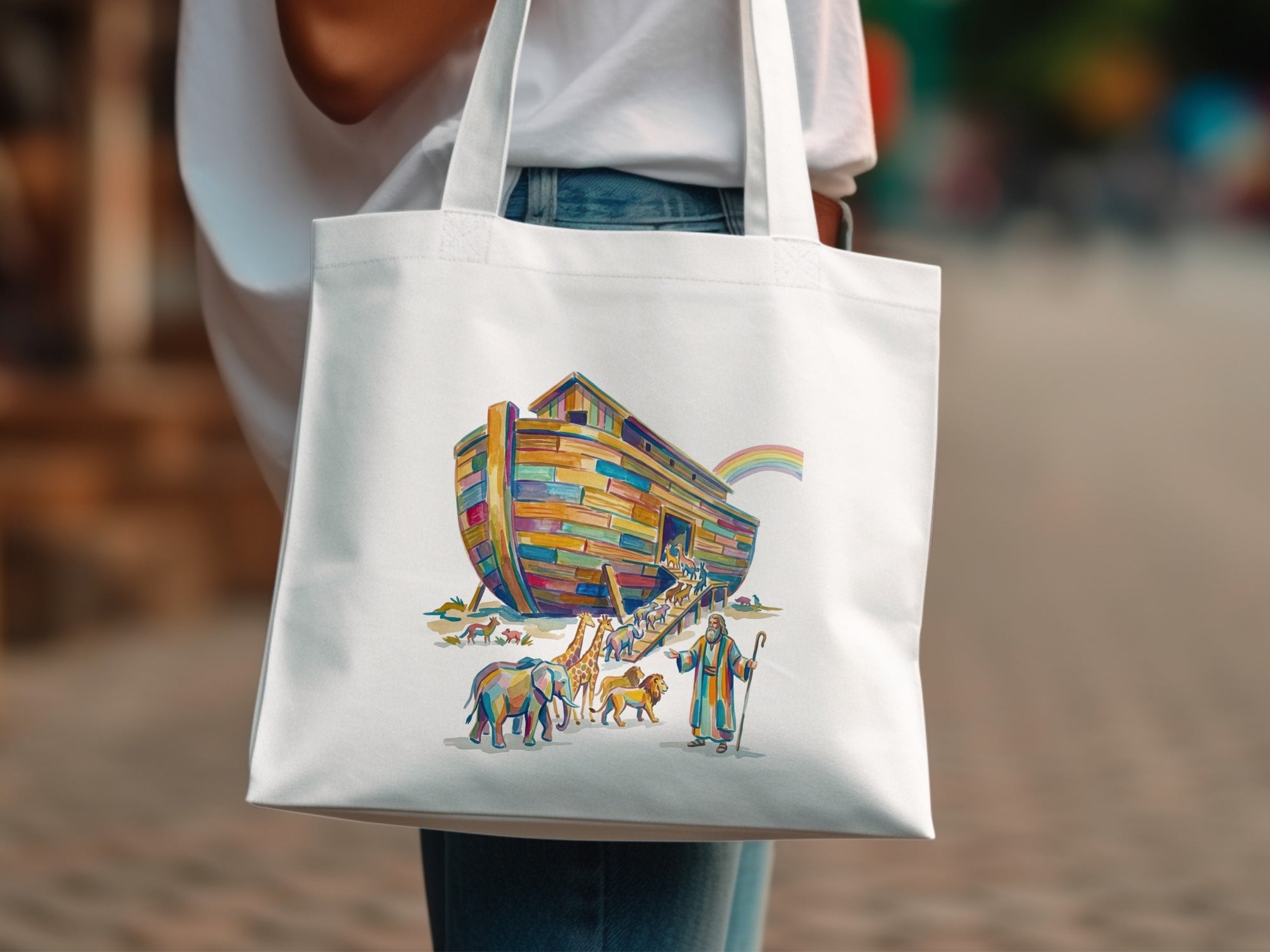 Noah's Ark with animals and a rainbow, on a white canvas tote bag.