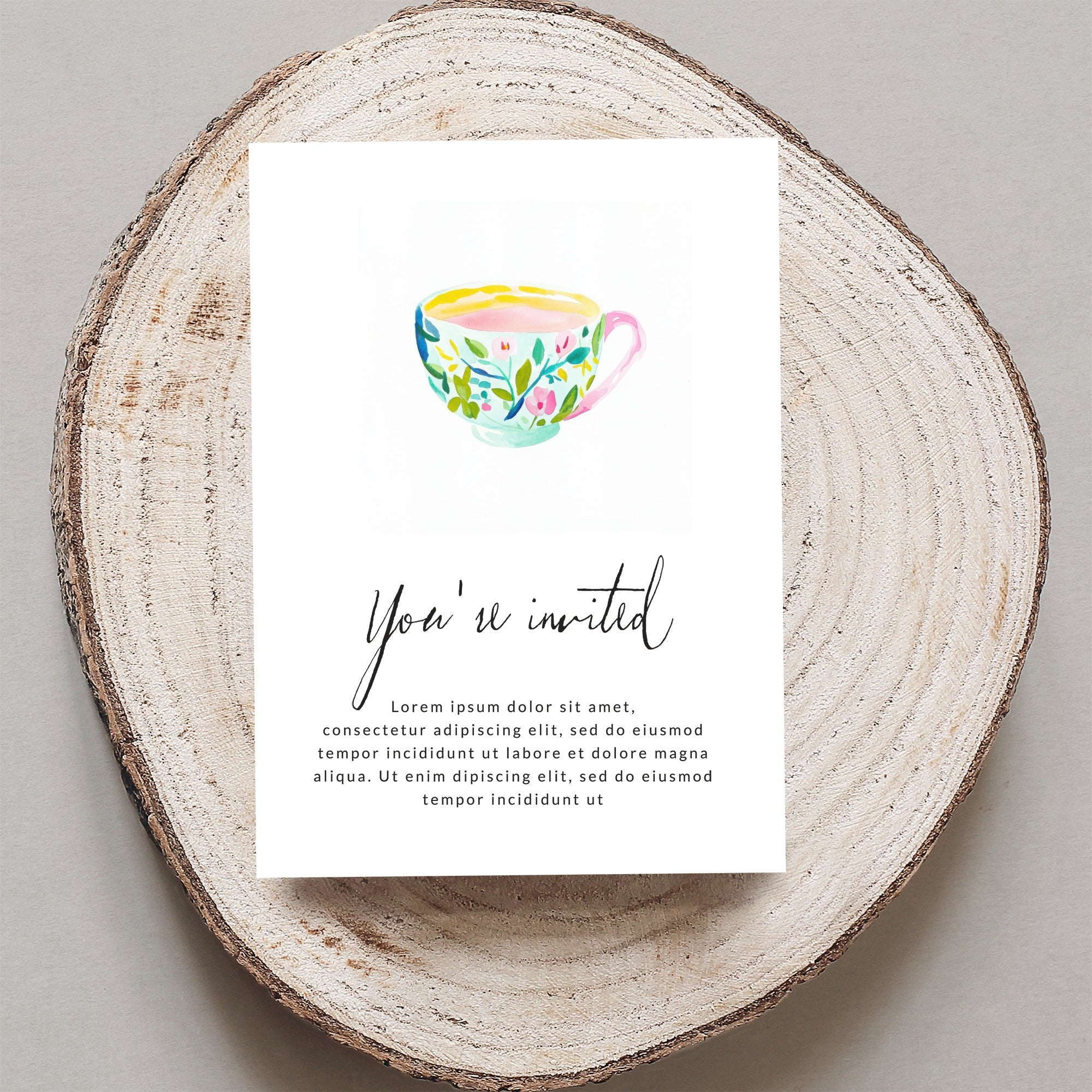 Invitation with floral teacup and "You're invited" text.