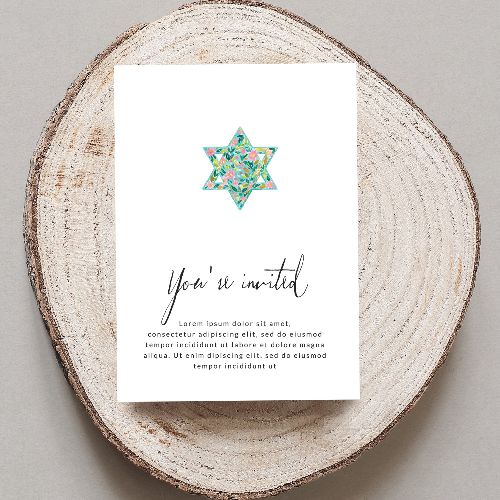 Invitation card with floral Star of David and "You're invited" text.