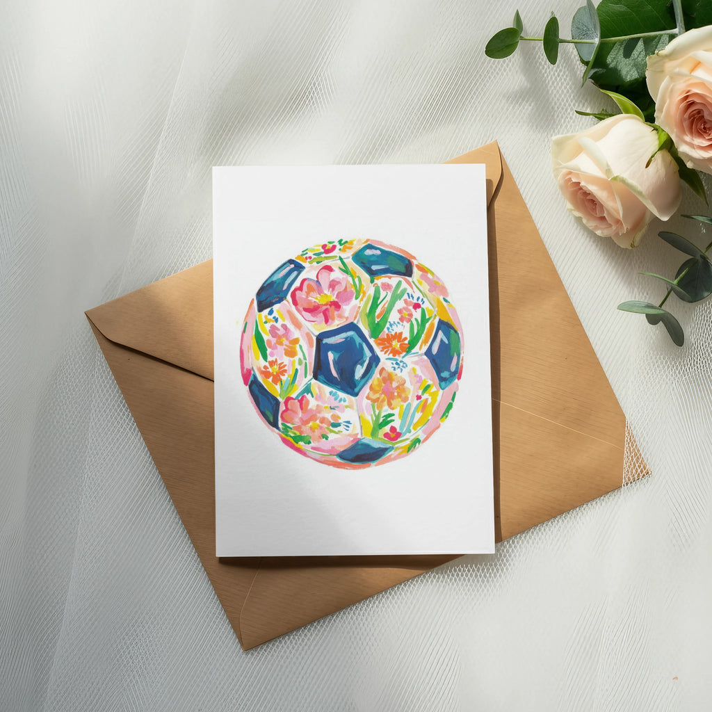 Watercolor soccer ball design on a card with envelope and roses.