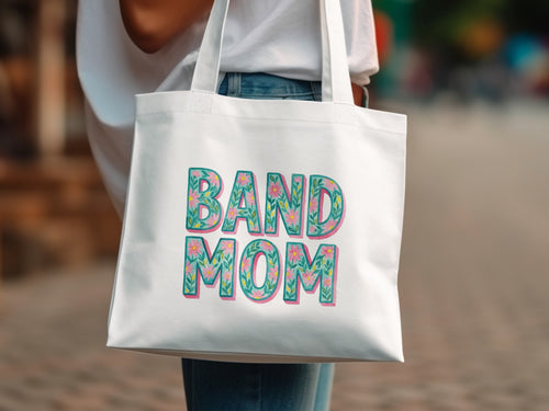 White tote bag with "BAND MOM" in colorful floral lettering.