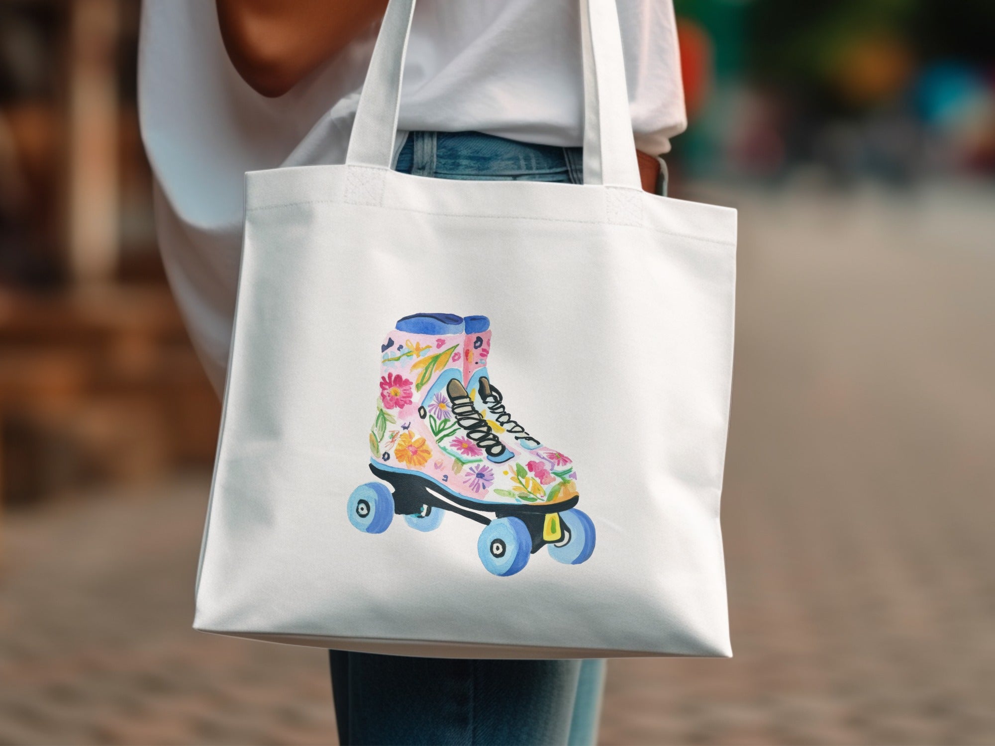 White tote bag featuring a colorful floral roller skate illustration.