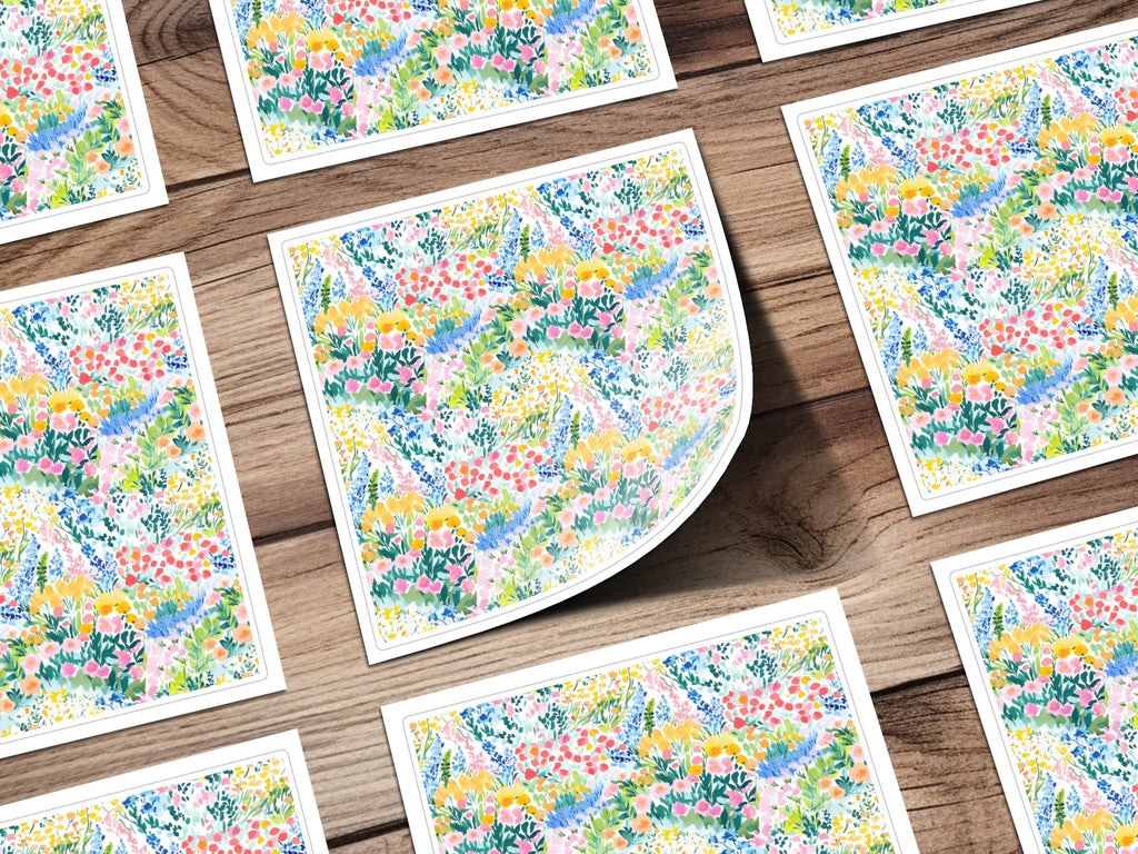 Floral pattern stationery cards scattered on a wooden surface.