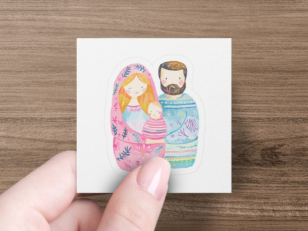 Nesting dolls depicting a family: parents with a baby, in soft pastel colors.