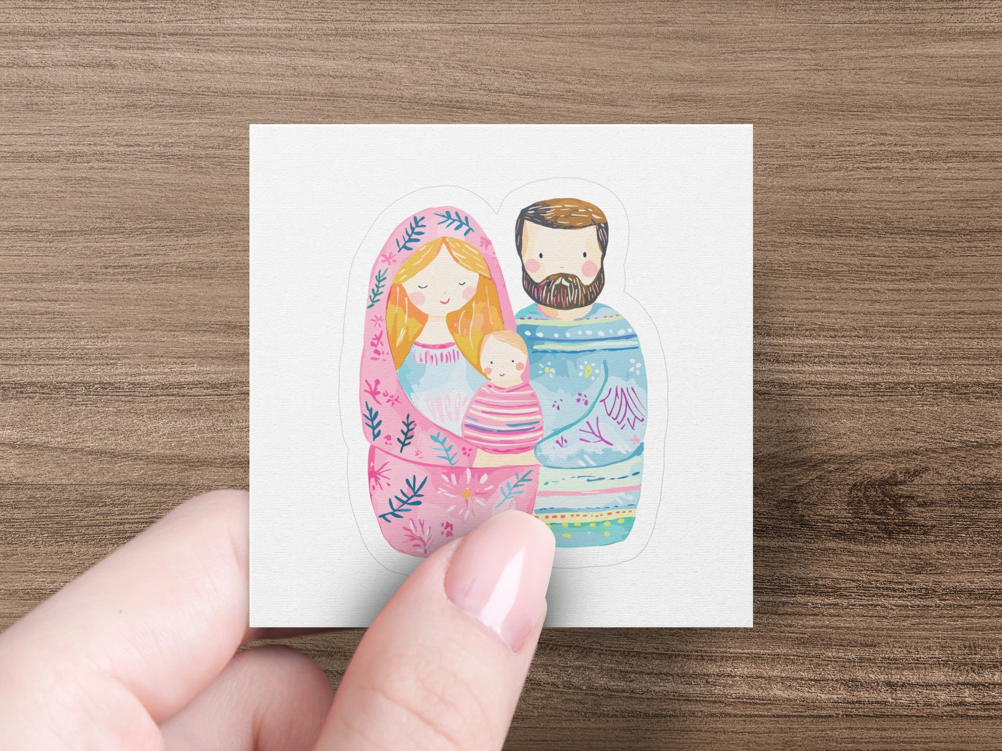 Nesting dolls depicting a family: parents with a baby, in soft pastel colors.