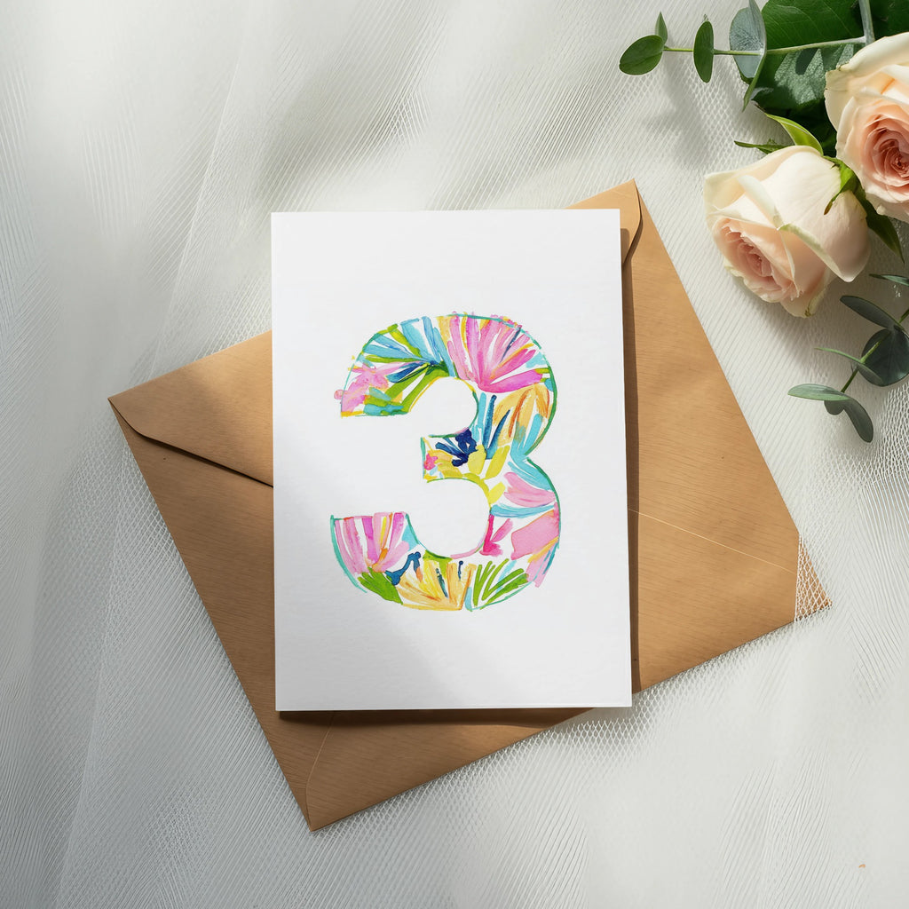Card with colorful tropical pattern number 3 on a kraft envelope.