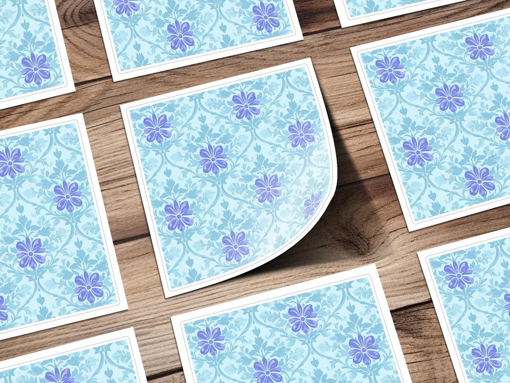 Blue floral pattern on light blue background on paper squares.