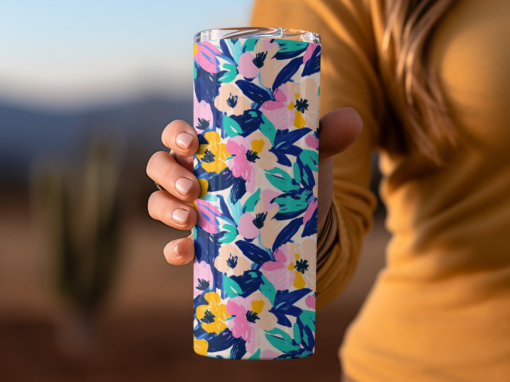 Tumbler with a vibrant floral pattern of pink, blue, and yellow flowers.