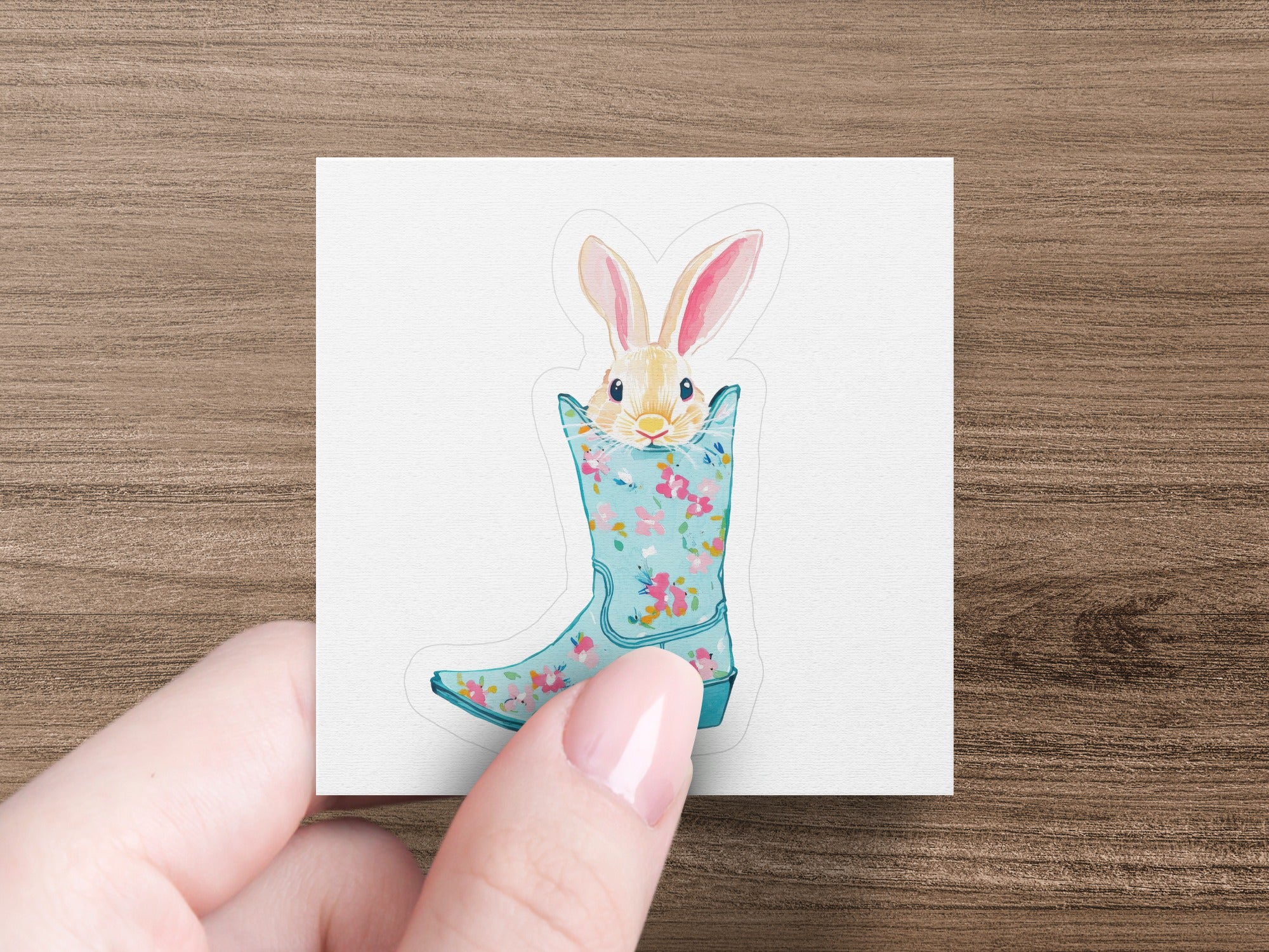 Cute bunny peeking from a floral patterned blue boot.