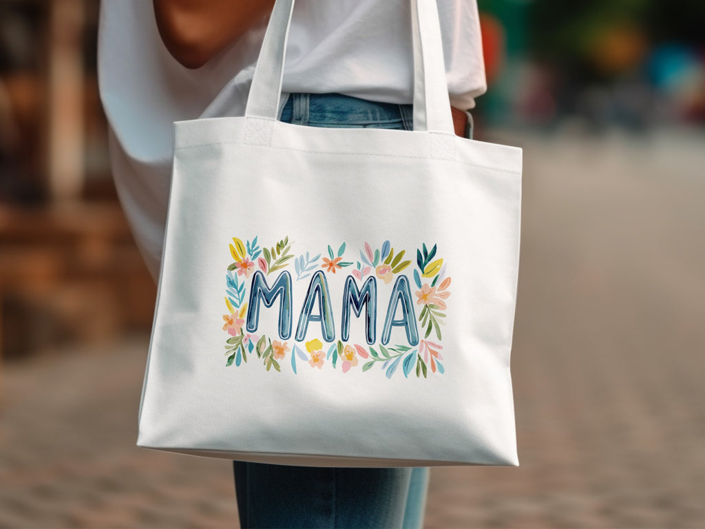 White canvas tote bag with "MAMA" in colorful watercolor floral lettering.