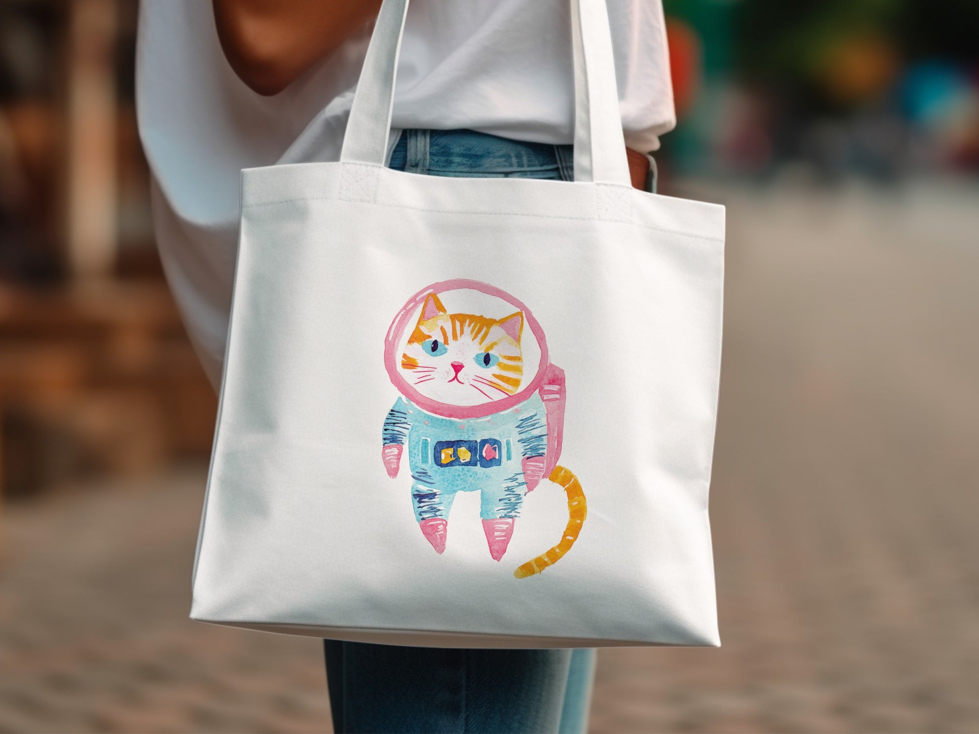 Tote bag with a watercolor illustration of a cat in an astronaut suit.