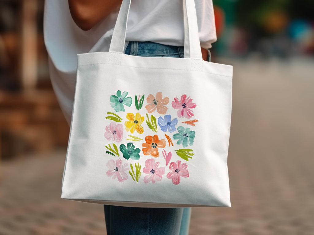 White tote bag with a grid of colorful watercolor flowers.