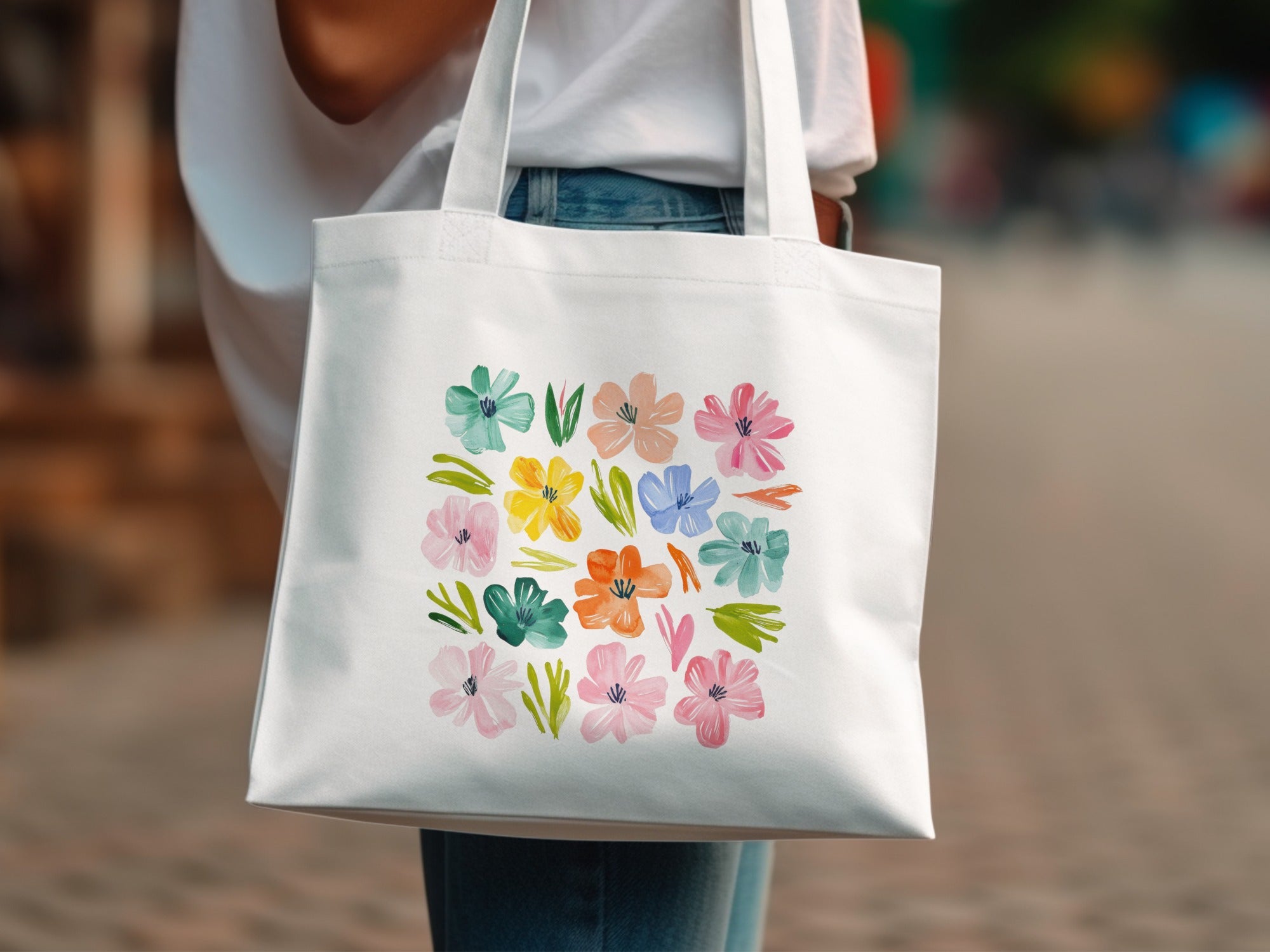 White tote bag with a grid of colorful watercolor flowers.