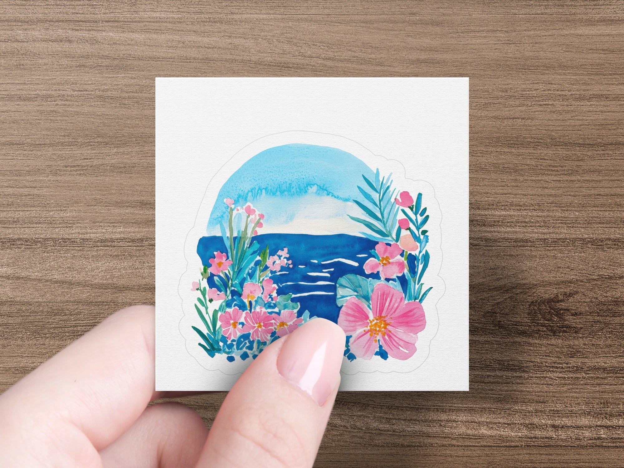 Watercolor painting of a vibrant seascape with flowers and palm leaves.