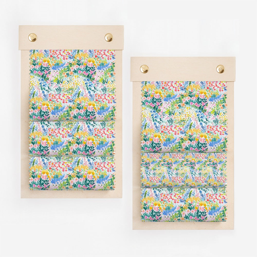 Two fabric swatches displayed on wooden boards with floral patterns.