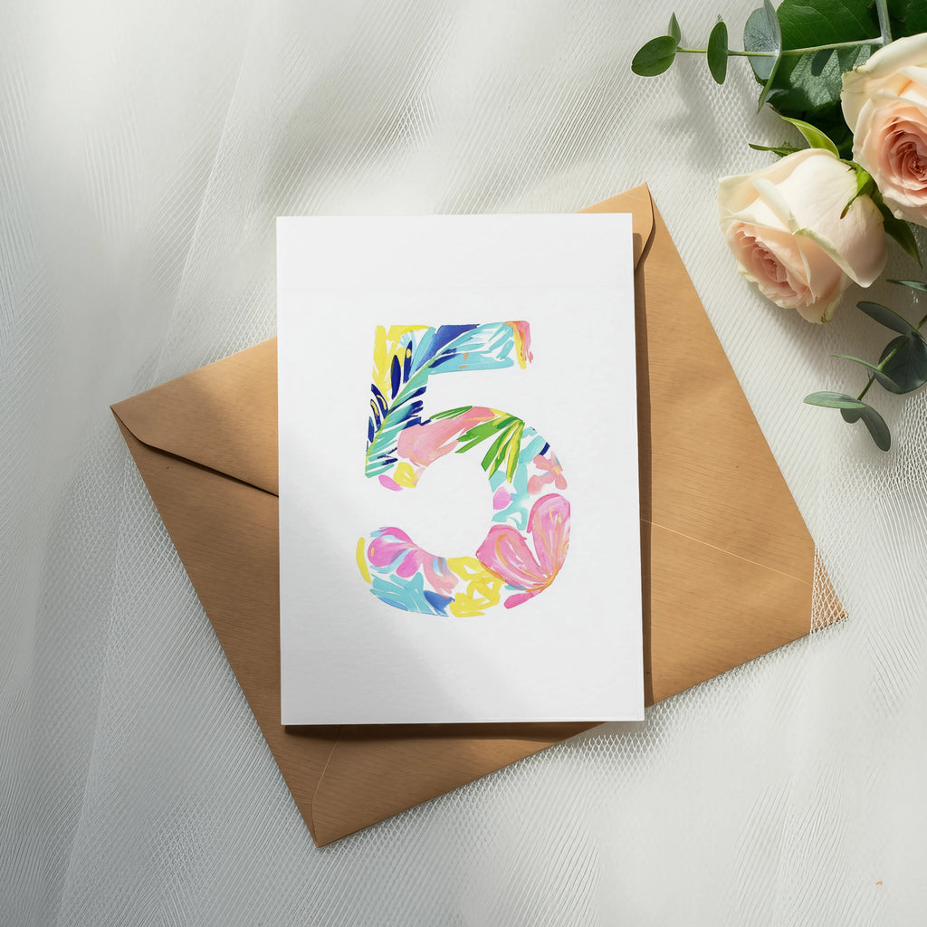 Card with colorful floral "5" design on brown envelope with roses.