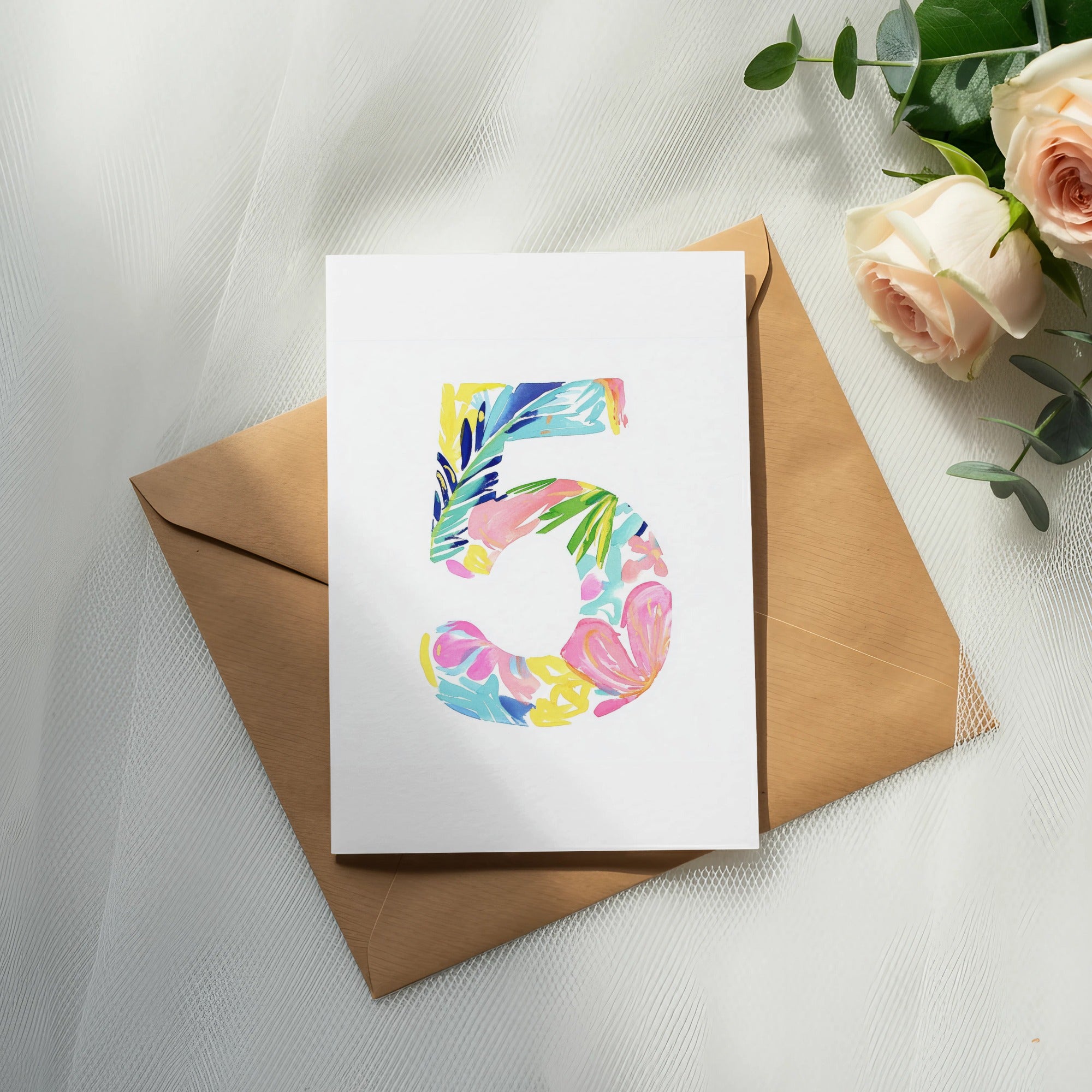 Card with colorful floral "5" design on brown envelope with roses.