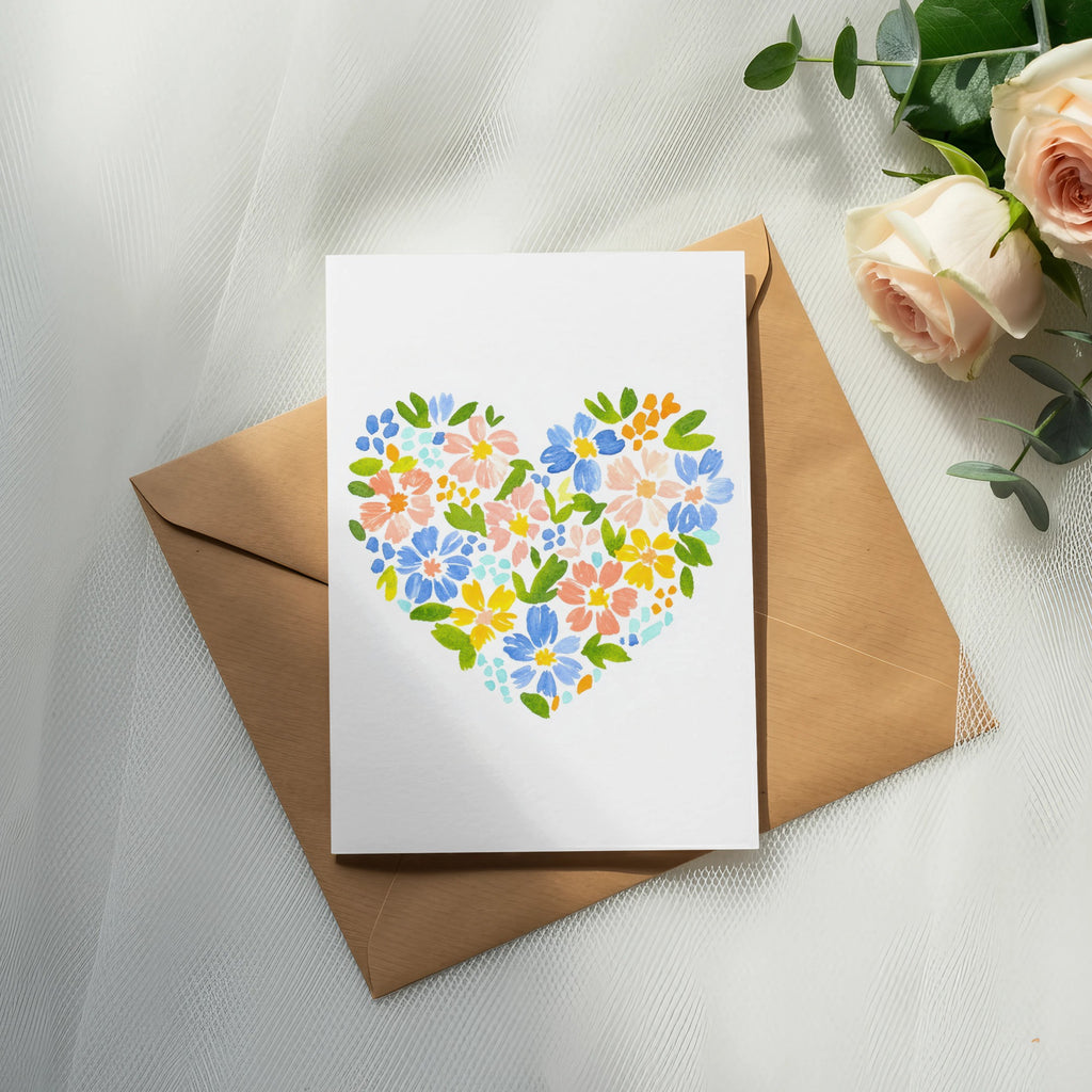 White card with colorful floral heart design on brown envelope.