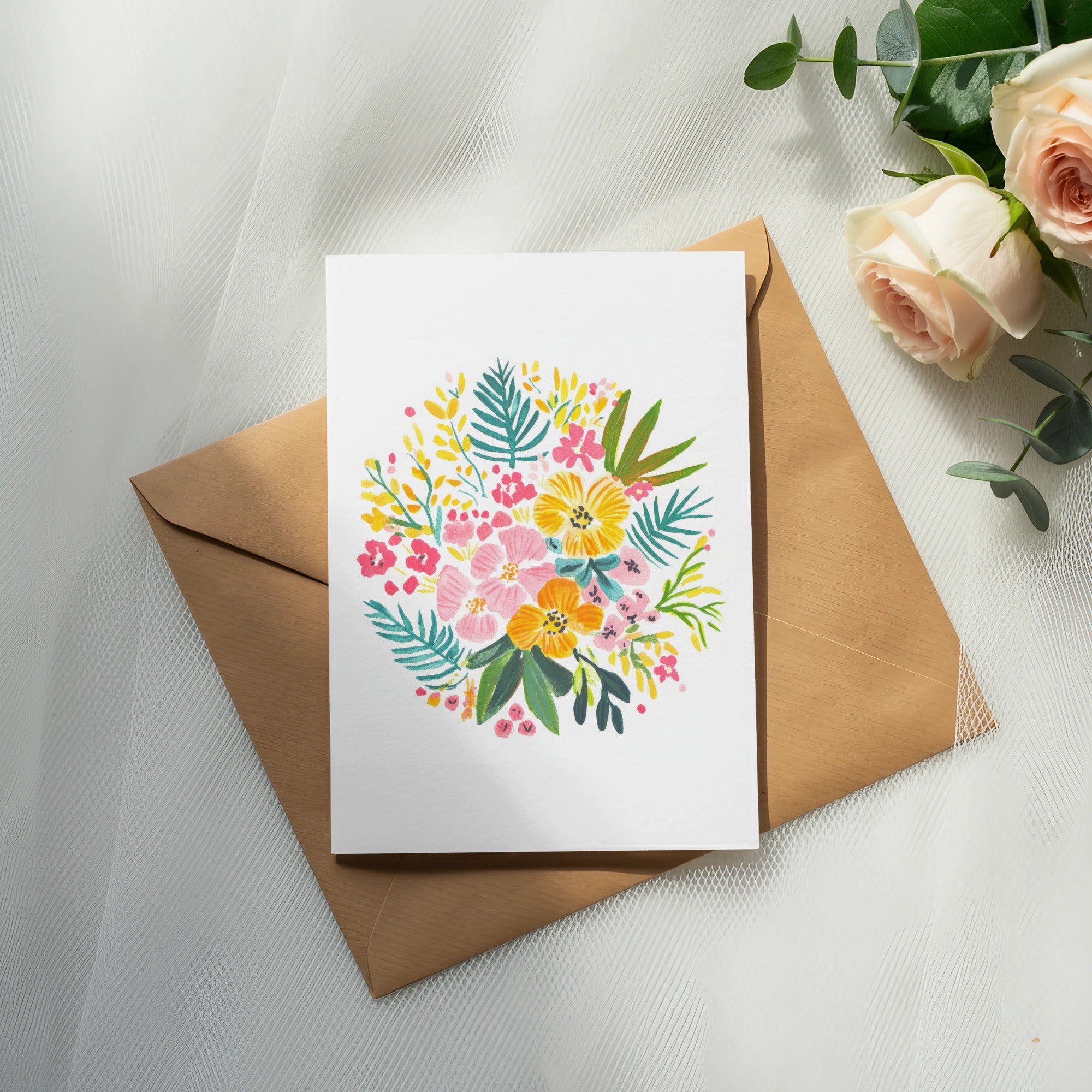 Card with colorful floral illustration on kraft envelope, with roses and eucalyptus.