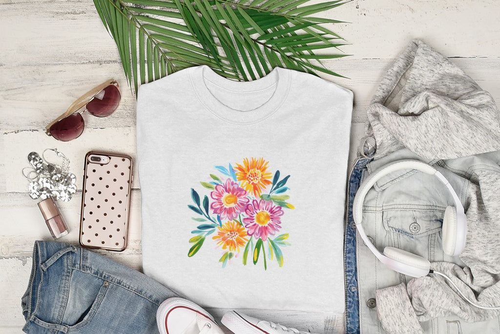 White t-shirt with a colorful floral illustration, surrounded by clothing and accessories.