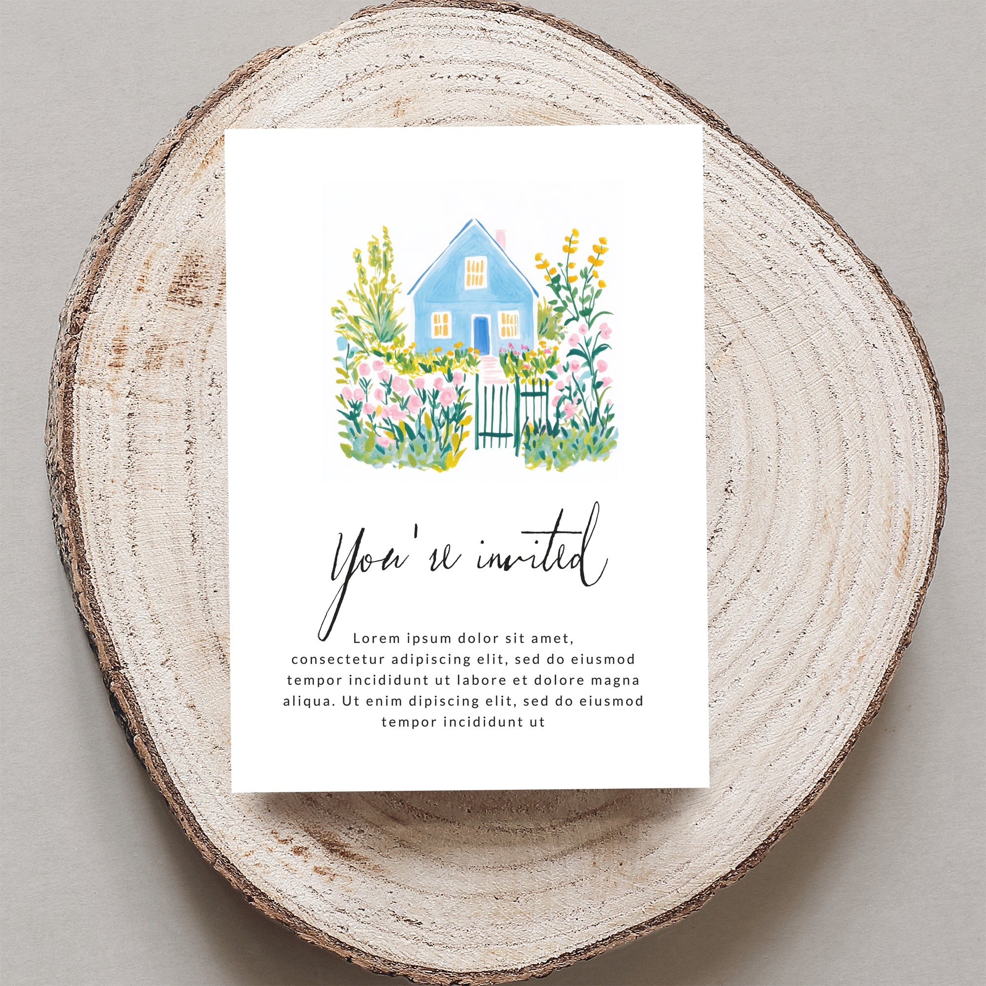 Watercolor blue house with garden on "You're invited" card with placeholder text.