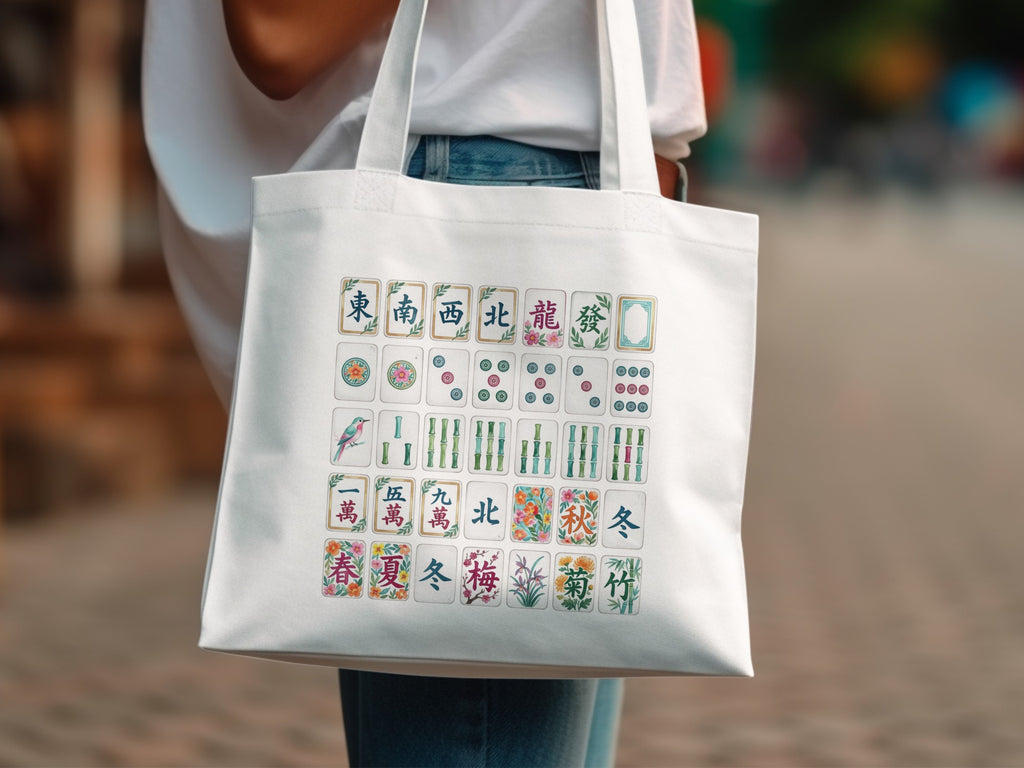 White tote bag with colorful mahjong tiles and floral designs.