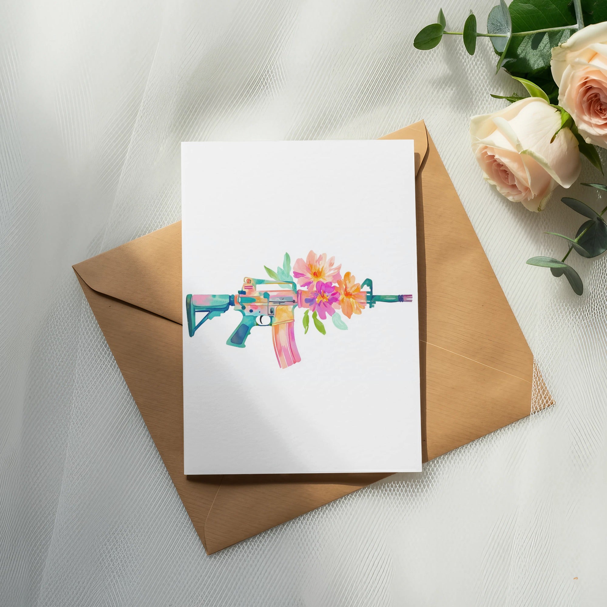 Watercolor rifle with flowers on a card over an envelope.