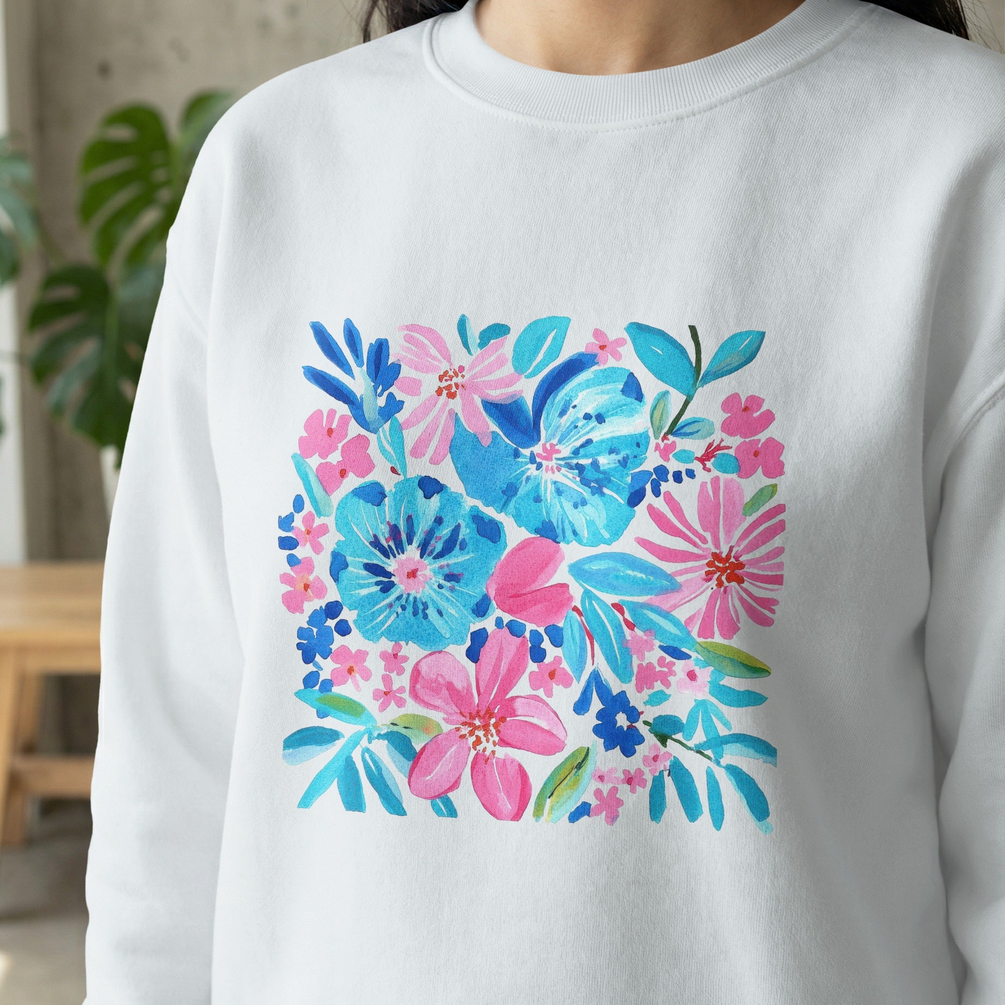 White sweatshirt with a colorful, abstract floral watercolor print.
