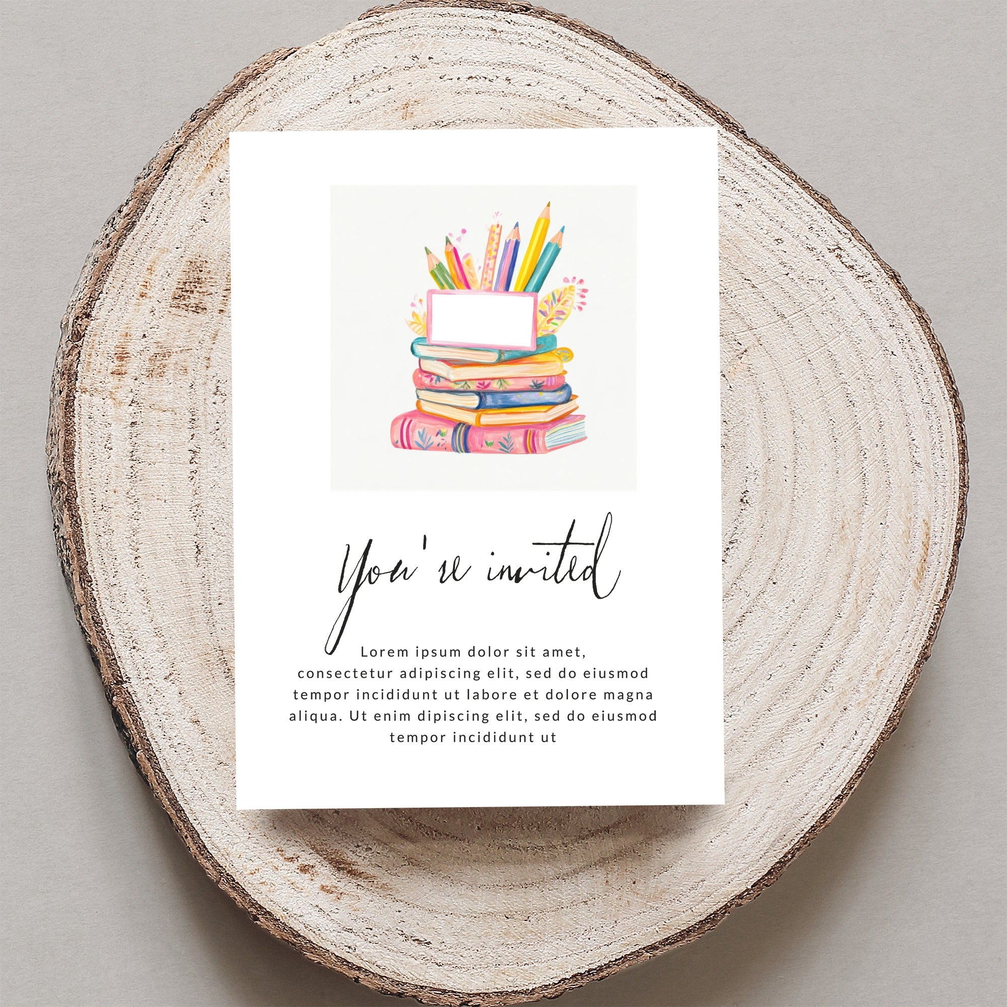 "You're invited" invitation with colorful books and pencils illustration.