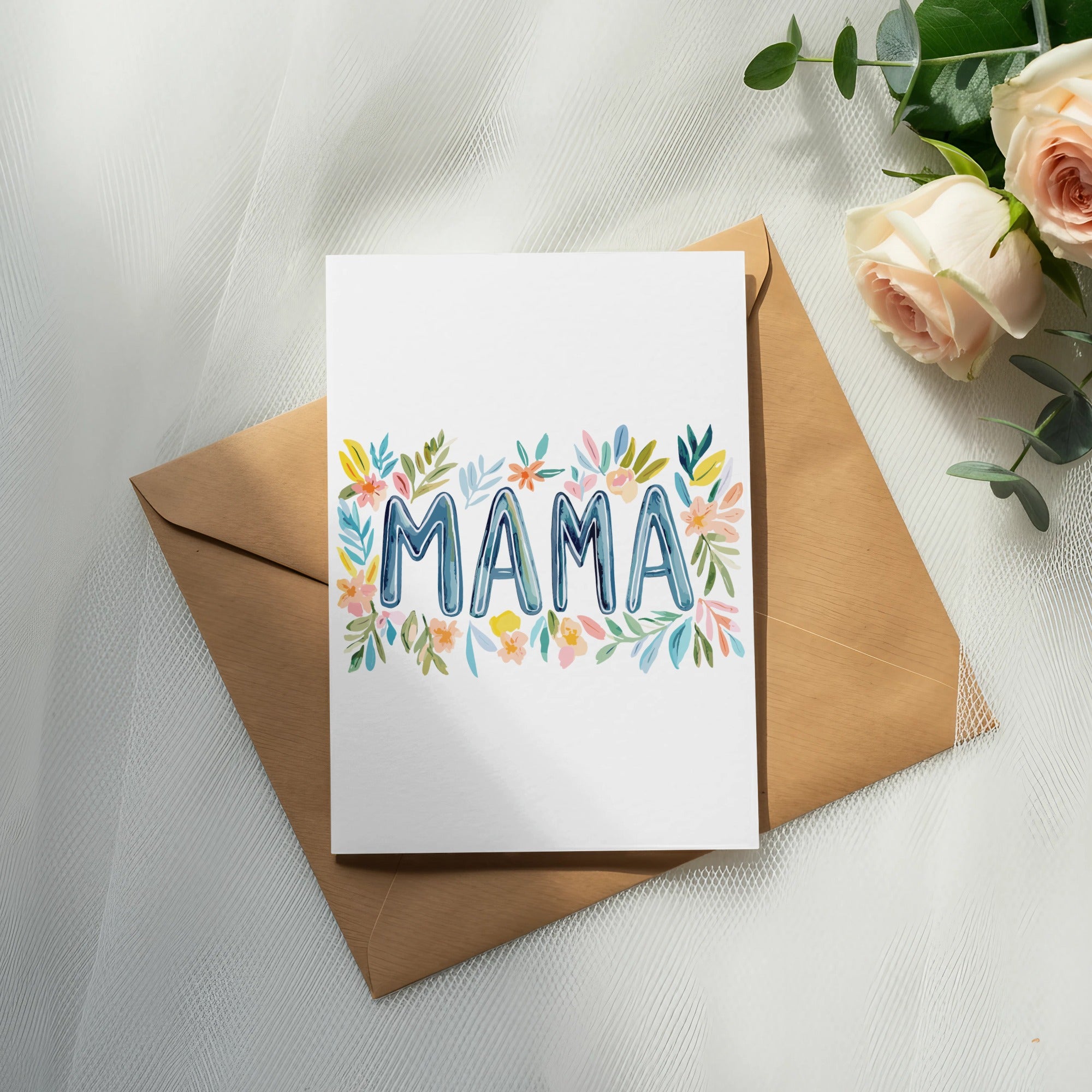 Greeting card with "MAMA" written in colorful watercolor flowers on an envelope.