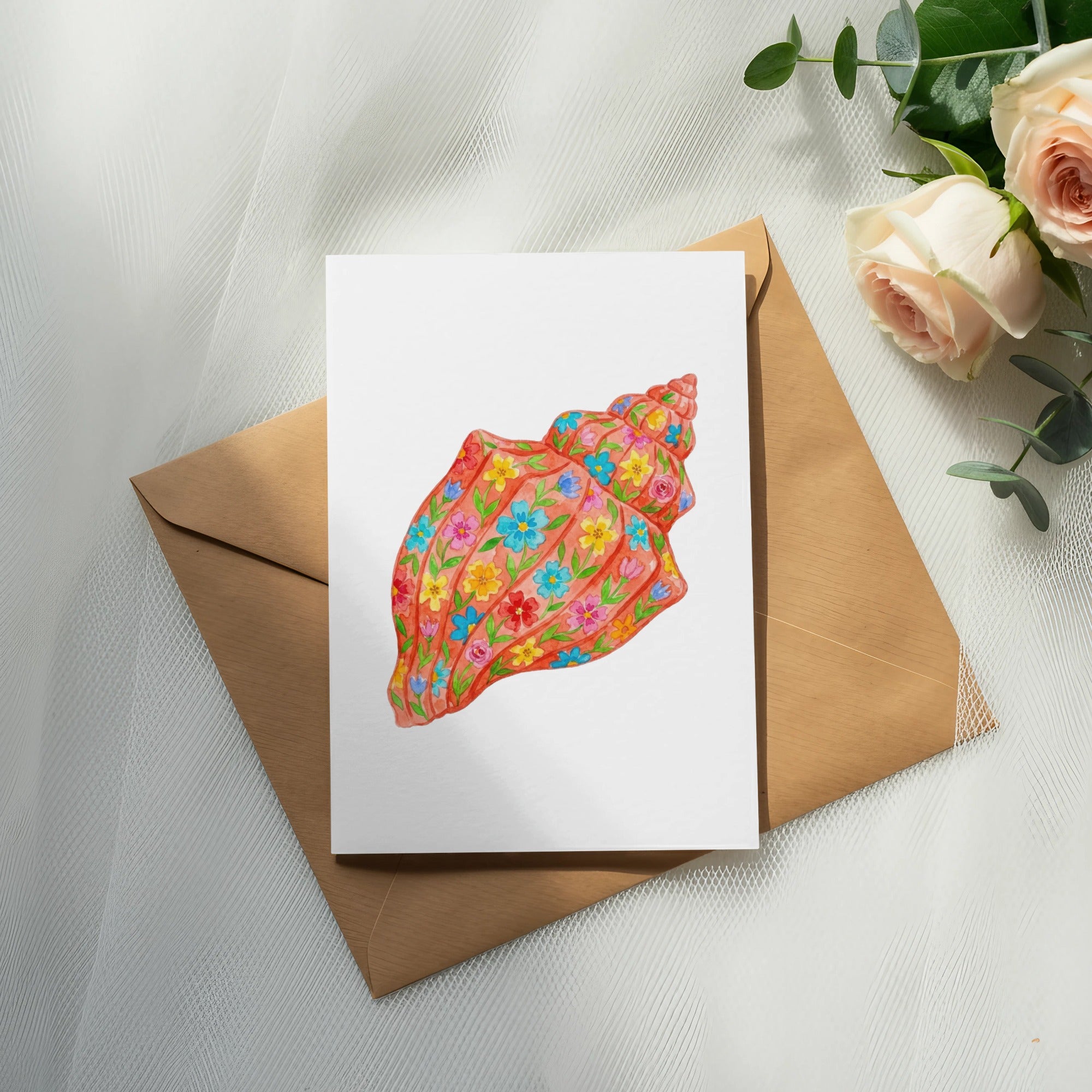Card with coral-colored seashell illustration on brown envelope, with roses.