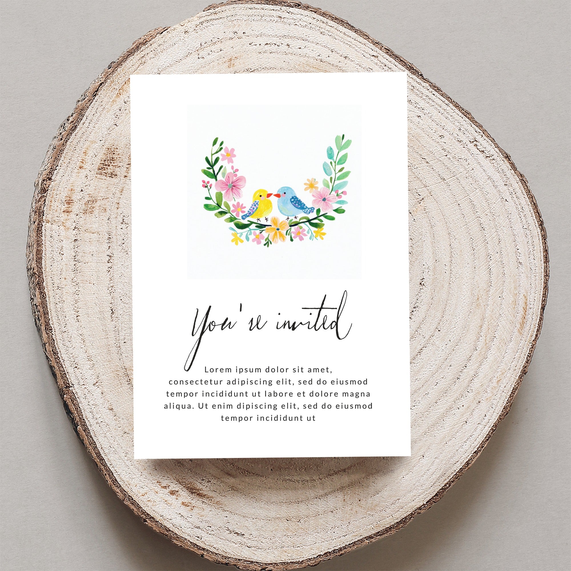 Invitation card with floral border and birds, "You're invited" text.