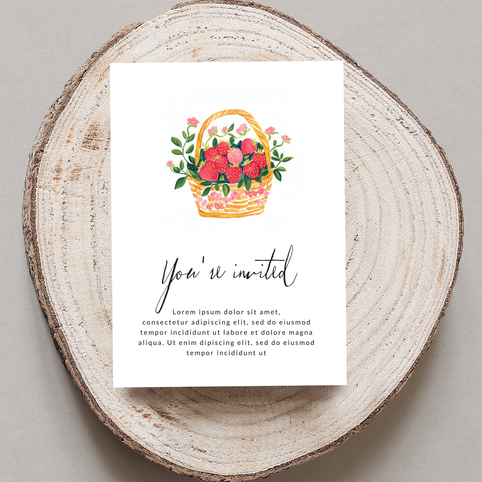 Invitation card with watercolor strawberries in a basket and "You're invited" text.