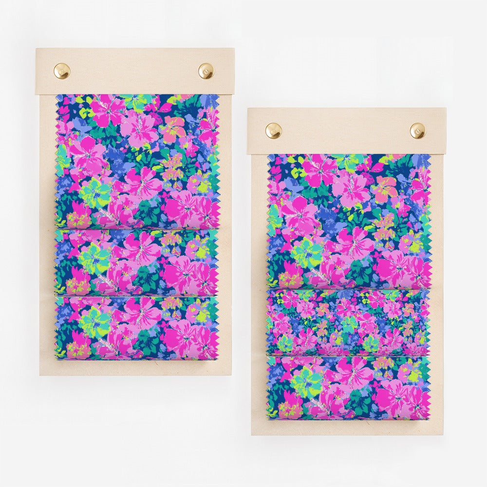 Two swatch books with floral fabric samples in pink, blue, and green.