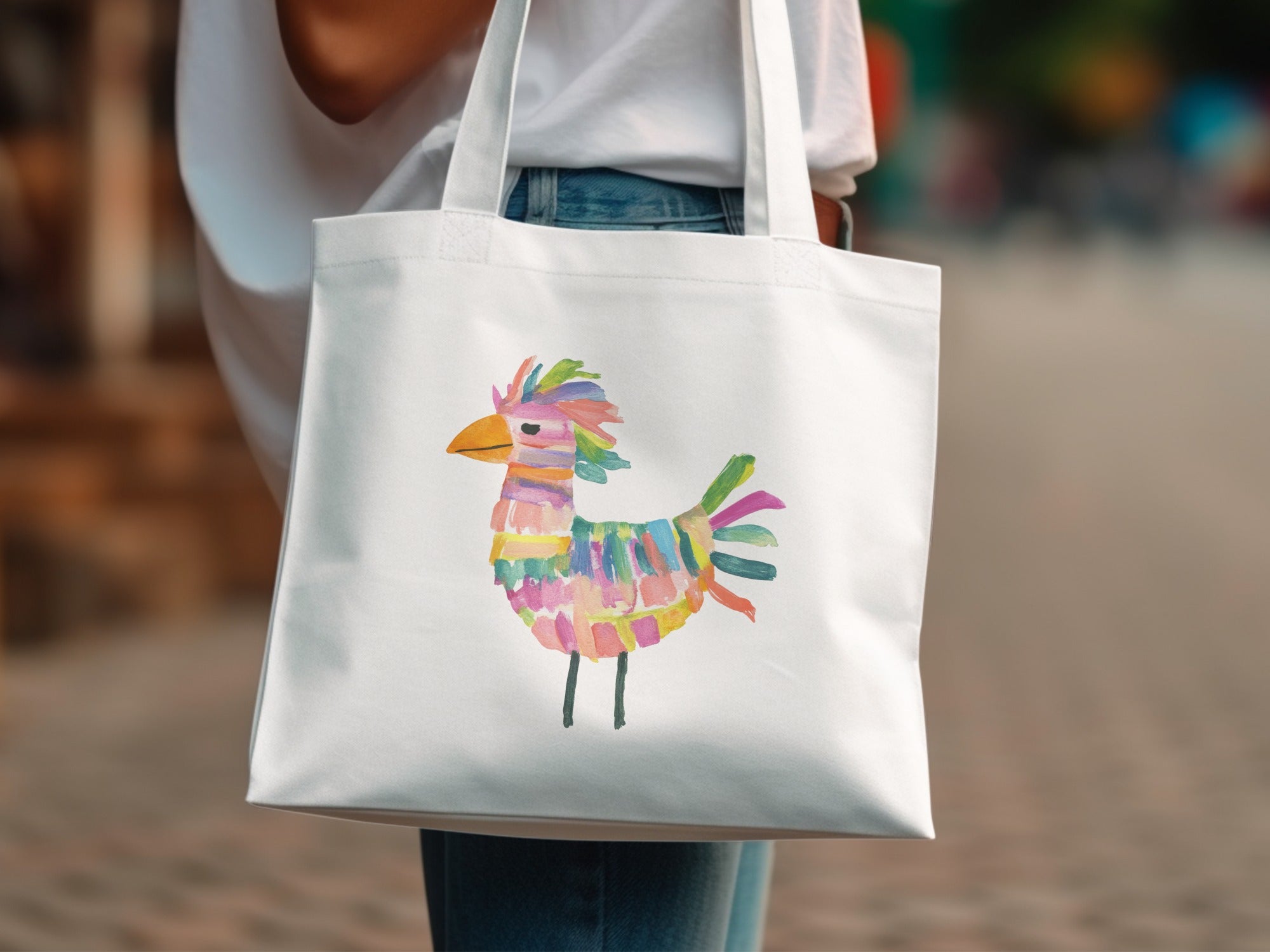 White canvas tote bag with colorful abstract bird illustration.