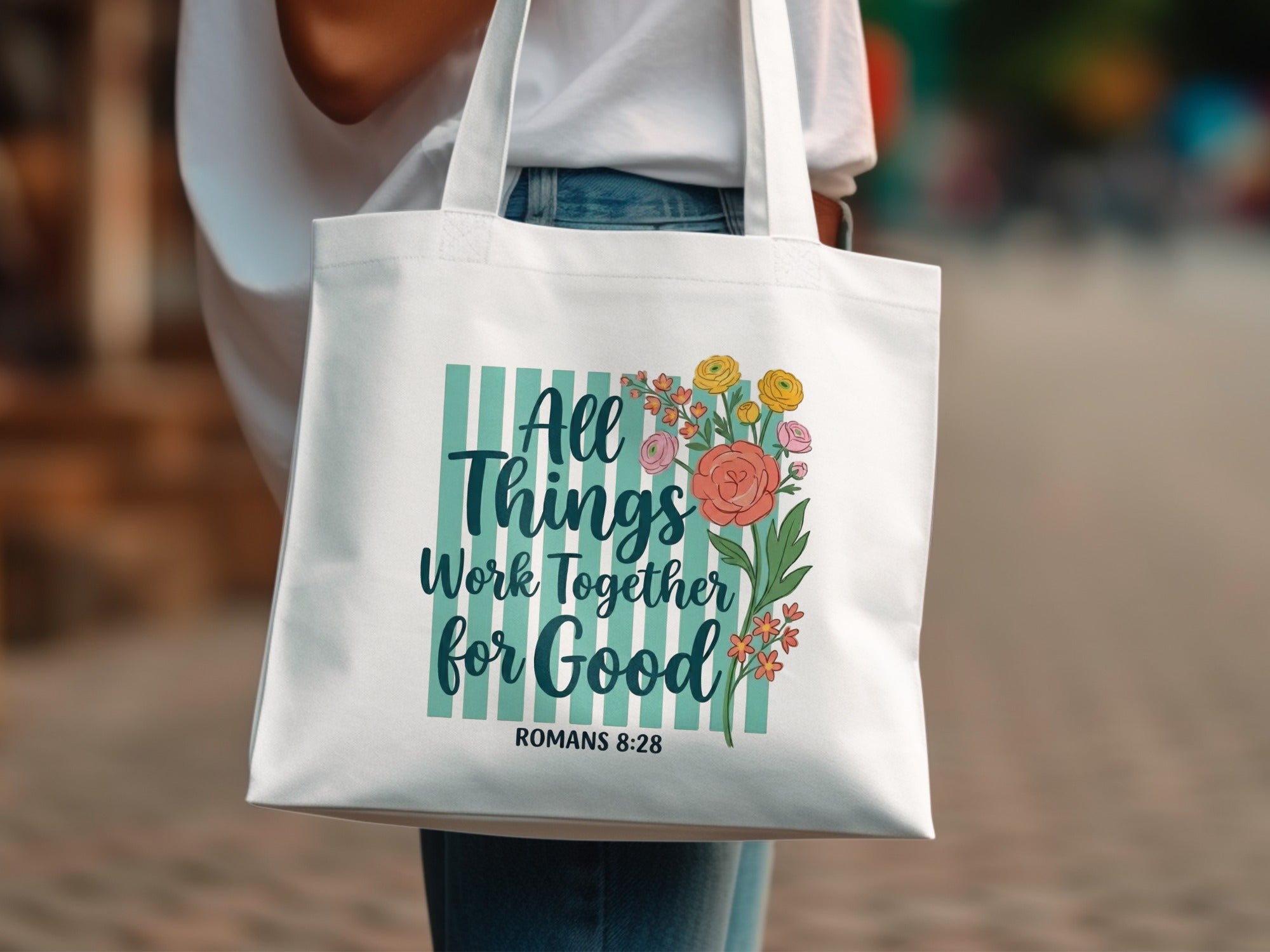 White tote bag with "All Things Work Together For Good" and floral design.