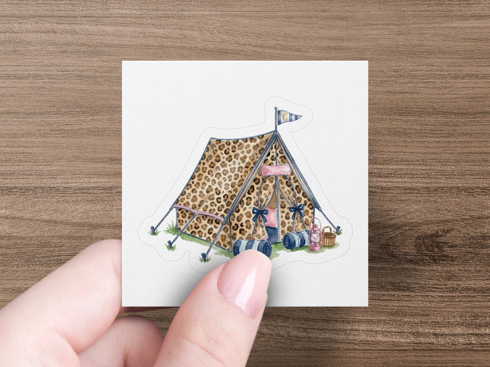 Leopard print tent with rolled sleeping bags and pink bows.