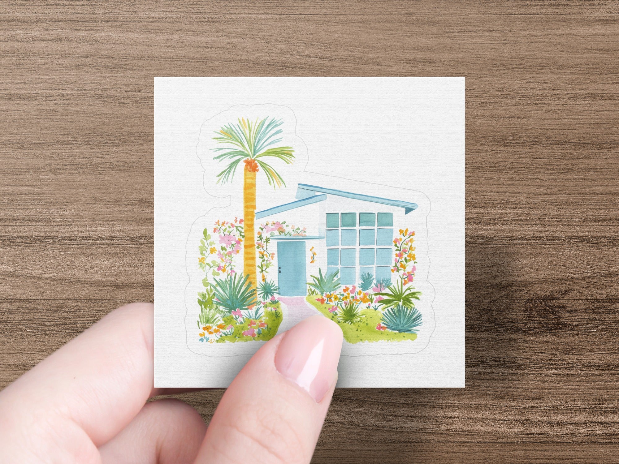 Watercolor illustration of a mid-century modern home with palm tree and colorful garden.