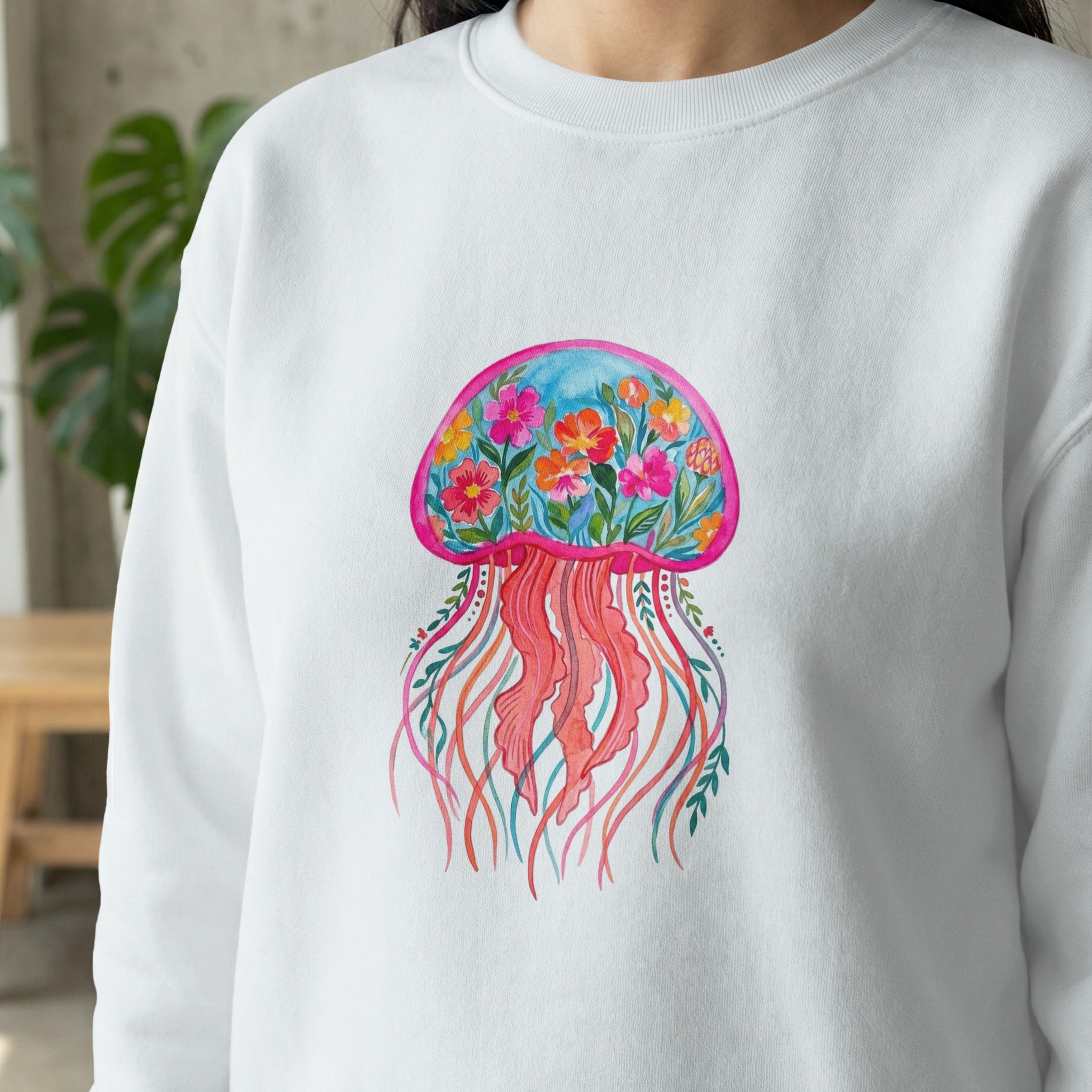 White sweatshirt with colorful jellyfish and floral design.