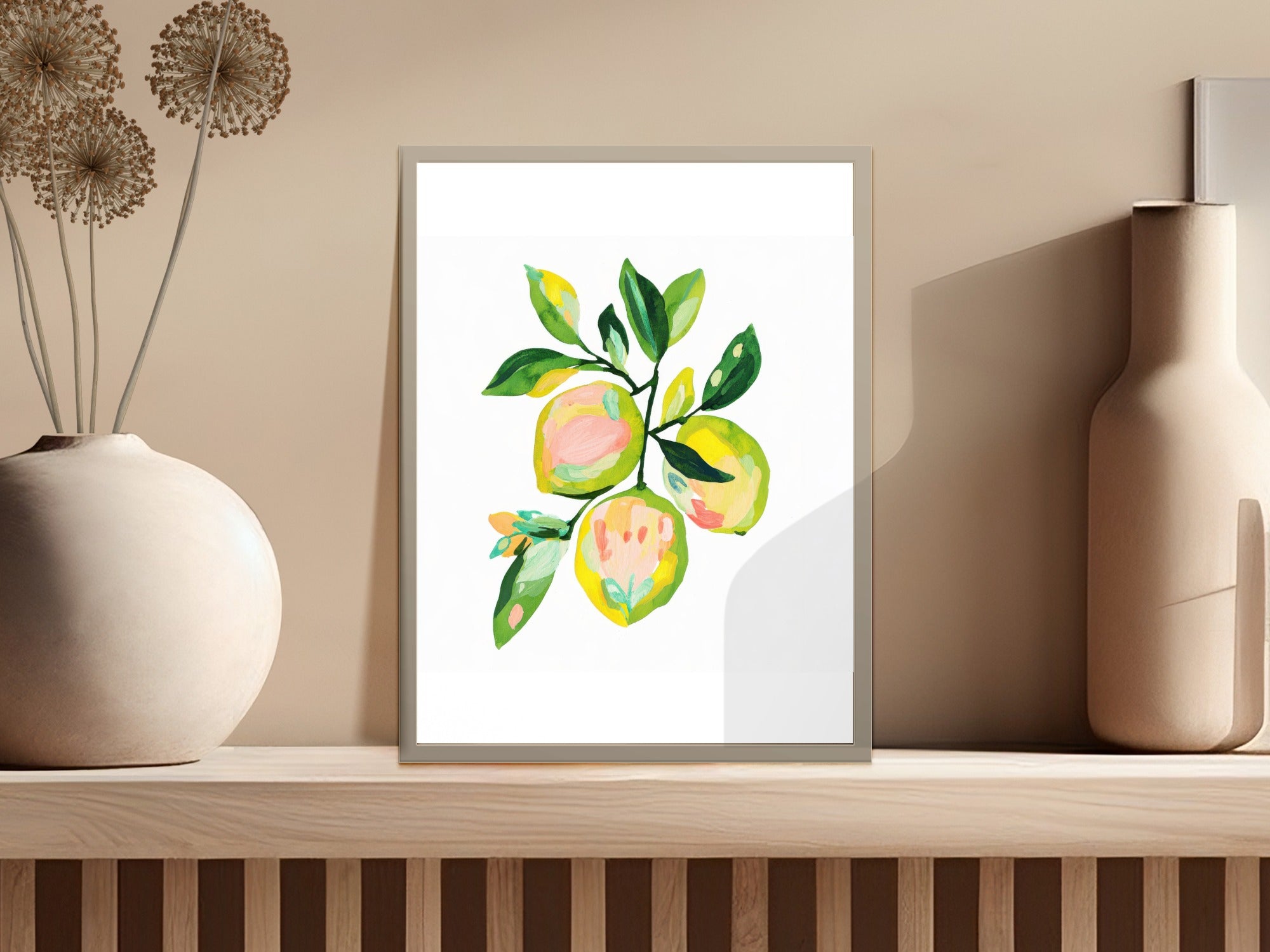 Watercolor painting of yellow and pink fruit with green leaves in a frame.