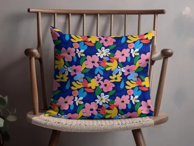 Blue throw pillow with a vibrant, abstract floral pattern.