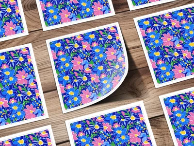 Pink and blue floral pattern stickers on a wooden background.