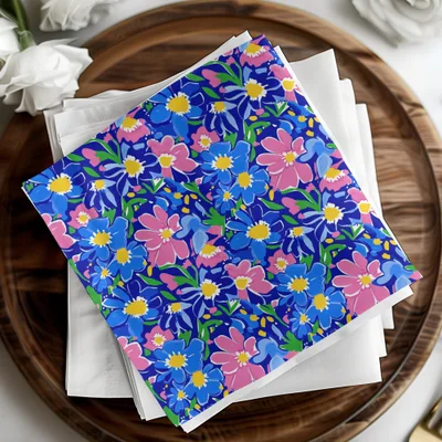 Blue and pink floral patterned napkins on a white cloth.