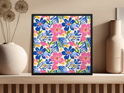 Framed abstract floral art with blue, pink, and yellow flowers on a beige wall.