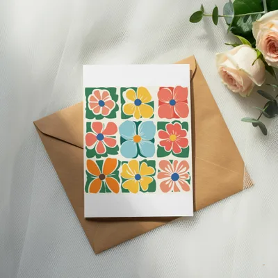 Greeting card with colorful geometric floral pattern on brown envelope.