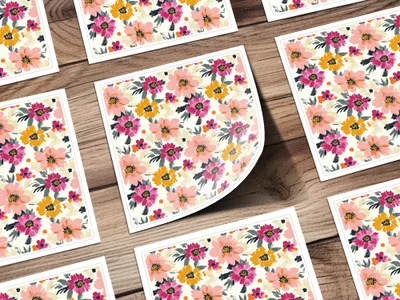 Floral pattern on cards with warm colors on a wooden background.