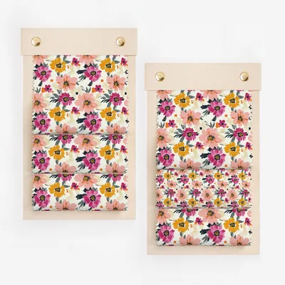 Two fabric swatches with floral patterns of pink, yellow, and orange flowers.