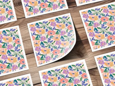 Floral pattern cards with pink, purple, and green flowers on a wooden background.