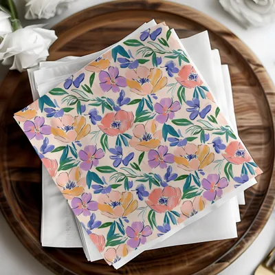 Floral patterned napkins in pink, purple, and blue on white napkins.