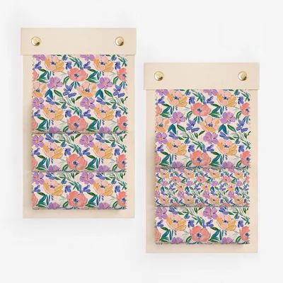 Two fabric swatches with floral watercolor pattern in purple, pink, and orange.